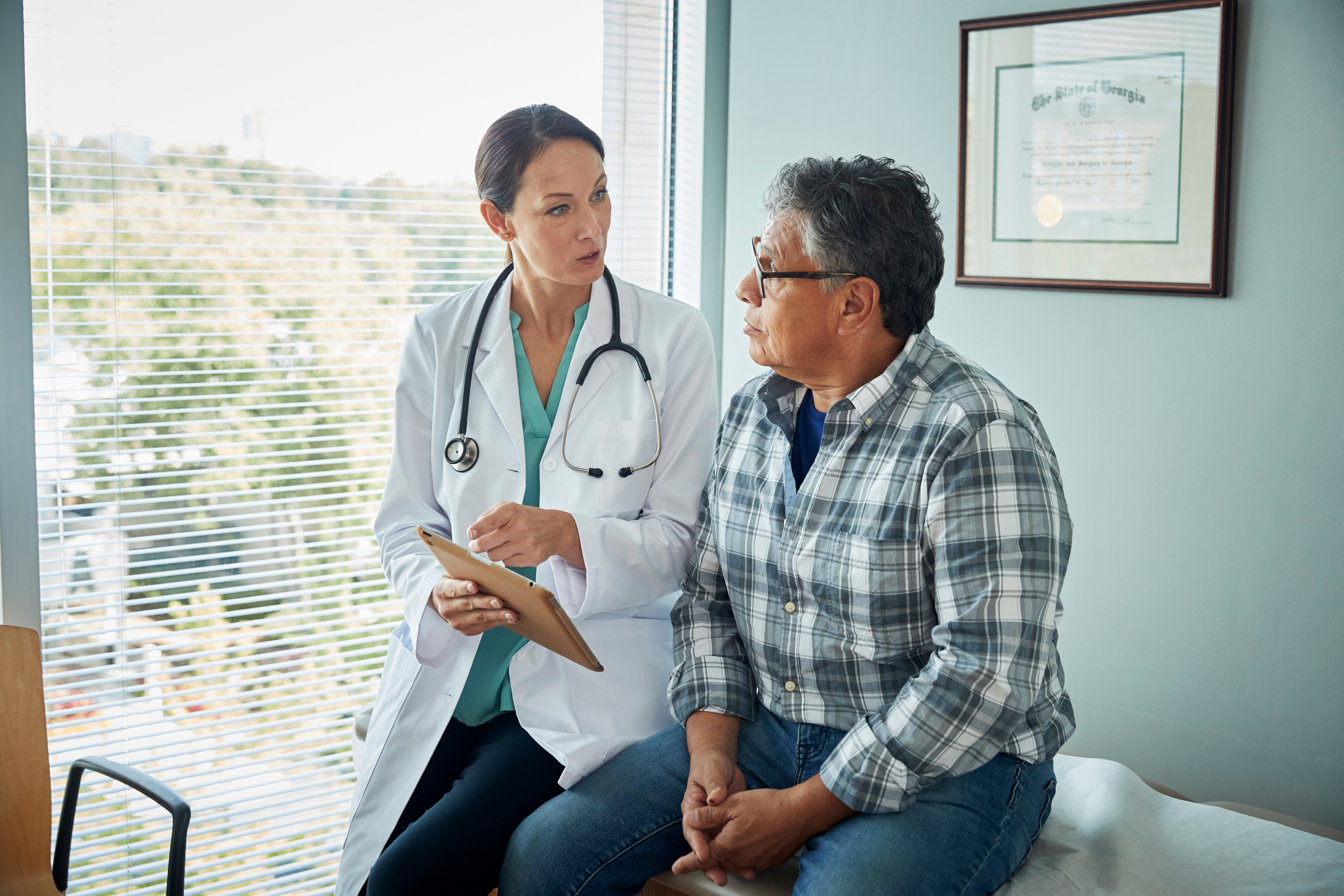 Doctor explaining prostate screening results to patient.